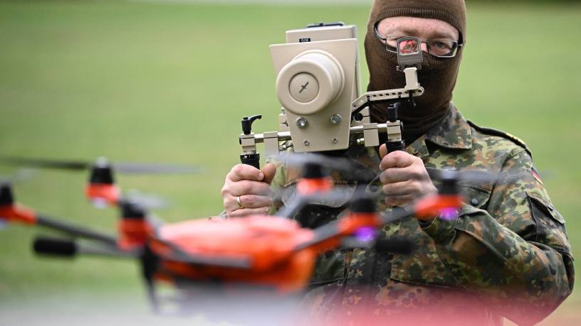 A soldier demonstrates the use of a handheld drone jammer 